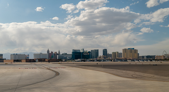 Las Vegas, Nevada - April 21 2021: View of the Las Vegas Strip Hotels and Casinos Skyline from the Airport with Large Clouds in the Sky