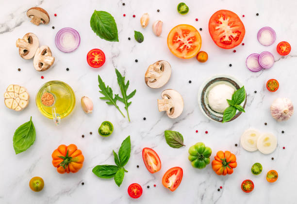 istock The ingredients for homemade pizza set up on white marble background. 1328585184