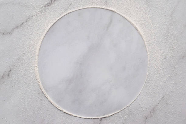 istock Scattered wheat flour on white marble background. Sprinkled wheat flour circle on white background. 1328585872