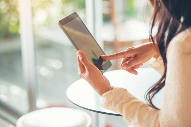 istock Asian woman using digital tablet shopping online, call, texting message internet technology lifestyle with smiling face. Asian woman touch smart tablet focus on hands using mobile app home office. 1328589872