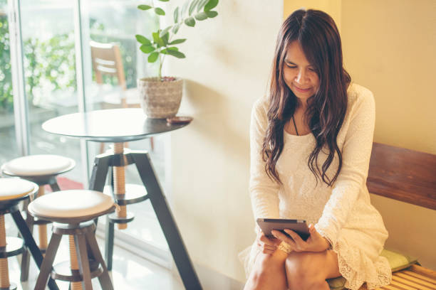 istock Asian woman using digital tablet shopping online, call, texting message internet technology lifestyle with smiling face. Asian woman touch smart tablet focus on hands using mobile app home office. 1328589873