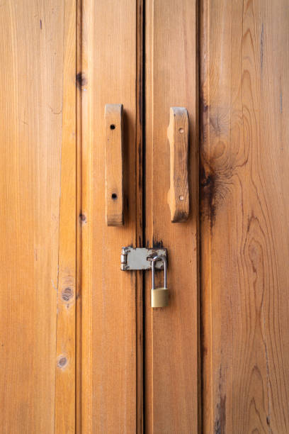 istock Double wooden door locked with a key 1328590698