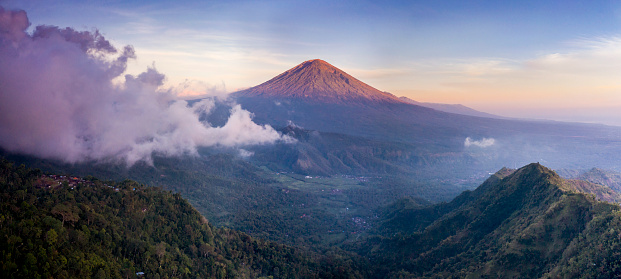 Panoramic landscape of the famous volcano Gunung Agung in Bali and taken at sunrise
