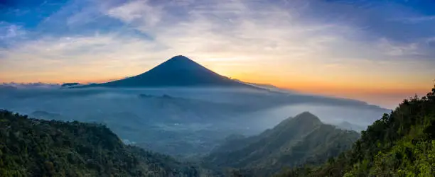 Panoramic landscape of the famous volcano Gunung Agung in Bali and taken at sundown