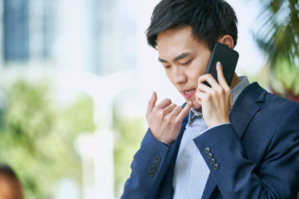 istock young asian business man talking on mobile phone 1328593484