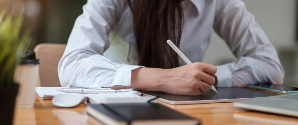 istock Business woman analysis financial report with tablet computer. 1328594836