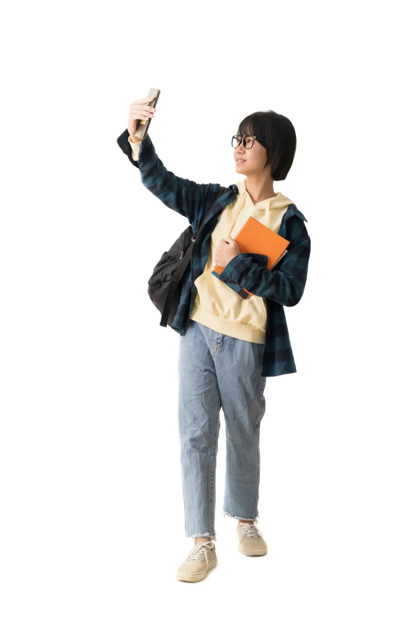 Happy Asian teen girl holding smart phone and book, isolate on white background.