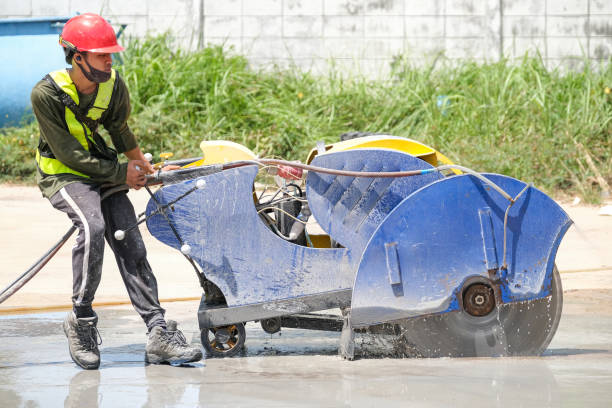 istock Worker contorl cutting machine are cutting concrete expansion and isolation joint pavement renovation work at construction factory building. 1328595683