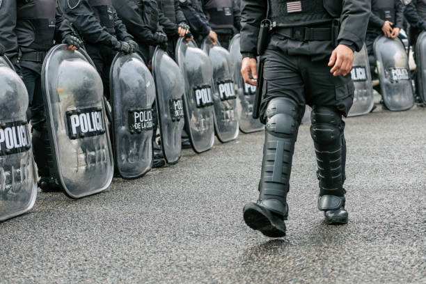 istock Police officers on duty with shields during street protest 1328597938