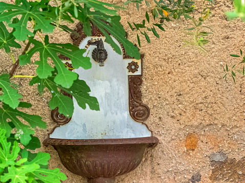 Water fountain found in a town courtyard in the countryside region of Trentino-South Tyrol and the Dolomites in Italy