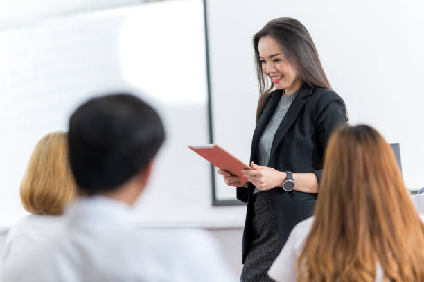 istock A middle-aged Asian woman teacher helping a student during on a class in the classroom university 1328598964