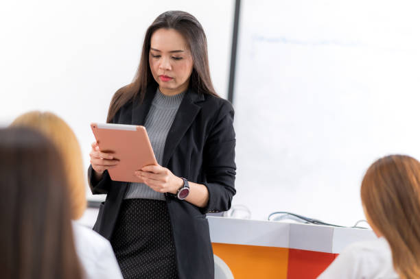 istock A middle-aged Asian woman teacher helping a student during on a class in the classroom university 1328598968
