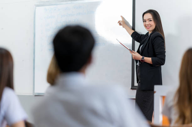 istock A middle-aged Asian woman teacher helping a student during on a class in the classroom university 1328598974