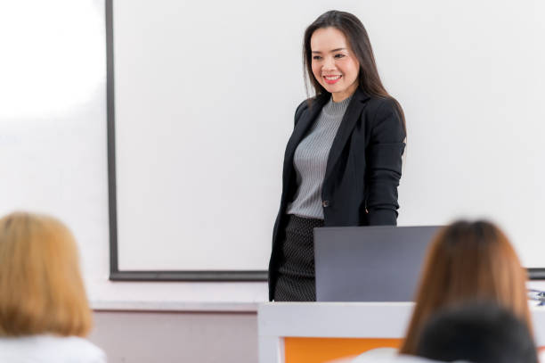 istock A middle-aged Asian woman teacher helping a student during on a class in the classroom university 1328599577