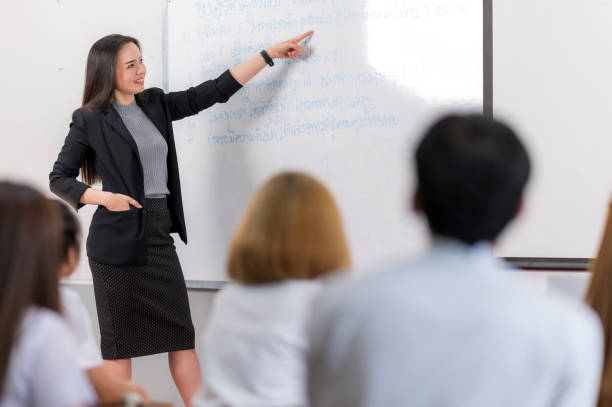 istock A middle-aged Asian woman teacher helping a student during on a class in the classroom university 1328599578