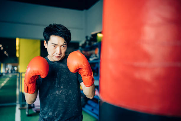 istock Asian young man training alone in gym. 1328601698