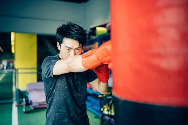 istock Asian young man training alone in gym. 1328601706