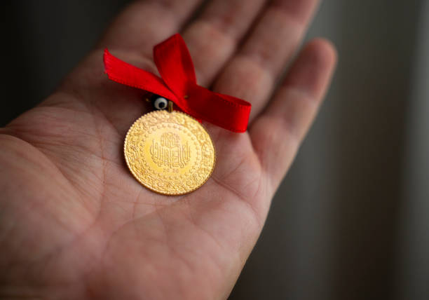 istock Human hand holding Turkish Gold coin in hand 1328603205