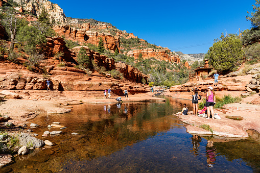 Coconino, Arizona USA - October 17, 2016: Slide Rock State Park with its natural rock water slides in the Oak Creek Canyon is a popular tourist destination near Sedona.