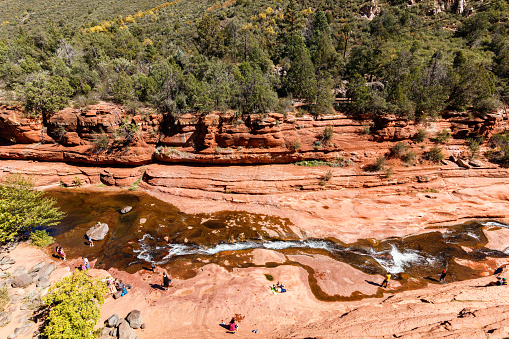 Coconino, Arizona USA - October 17, 2016: Slide Rock State Park with its natural rock water slides in the Oak Creek Canyon is a popular tourist destination near Sedona.