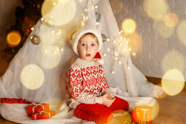 istock Cute child cheerful mood play near christmas tree. It is miracle. 1328607976