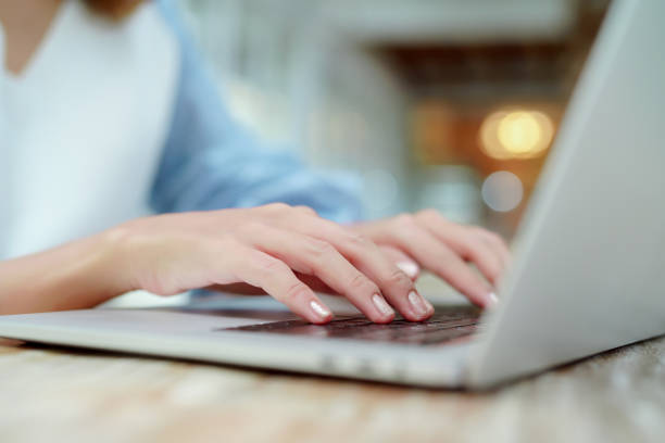 istock Close Up Asian woman's hand pressing her finger on the keyboard of a notebook computer. 1328608733
