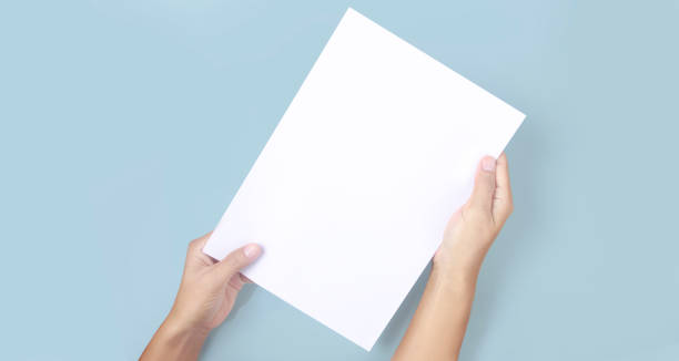 istock Hands holding paper blank for letter paper 1328608988