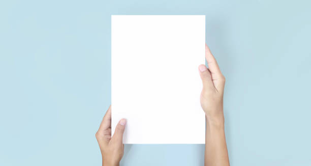istock Hands holding paper blank for letter paper 1328608992