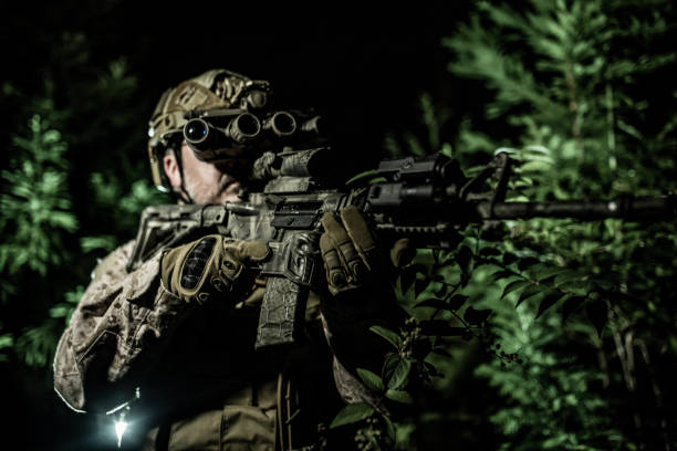 istock Night Military Spec Ops operator with panorama night vision goggles in action 1328609867