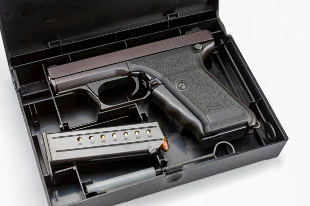 istock Automatic gun and bullets in a plastic hard case on white background 1328612869