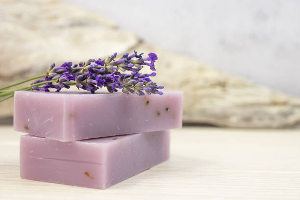 istock Handmade lavender soap with natural fresh lavender flowers on a gray background. Side view. 1328613980