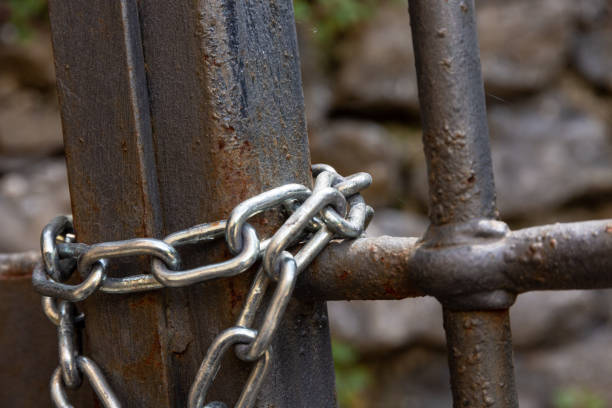 istock Chain on old metal fence 1328616092