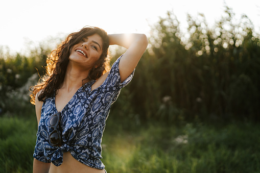 Happy young woman in summer nature