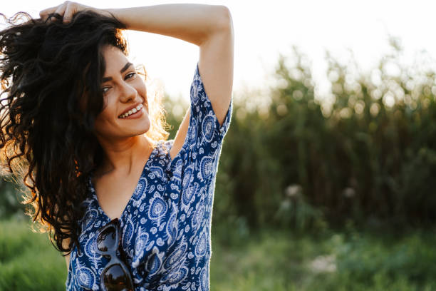 istock Happy young woman in summer nature 1328619148