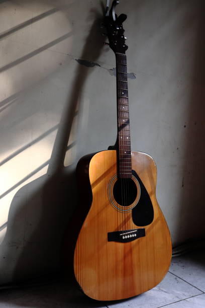 istock a guitar on the wall in the sun 1328620260