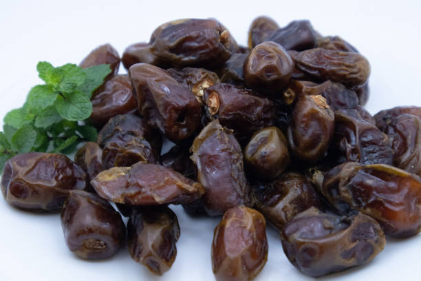 istock pile of dates with green leaf garnish 1328620479