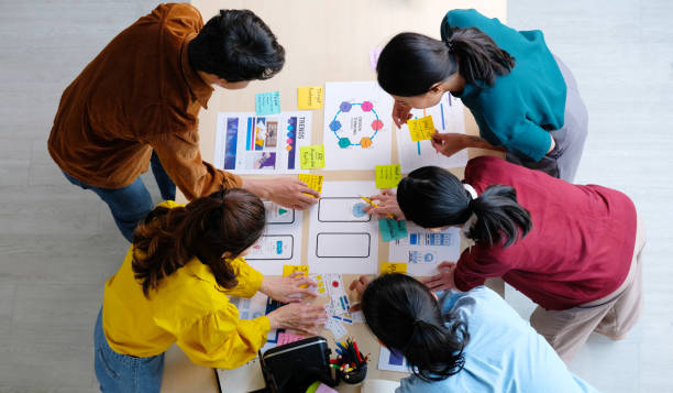 istock Brainstorm planing creative asian teamwork, Group of asia mobile phone app developer team meeting for ideas about screen display prototype smartphone layout, ux startup small business, top view 1328621150