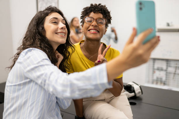 istock two multiracial friends taking selfie in coworker 1328621238