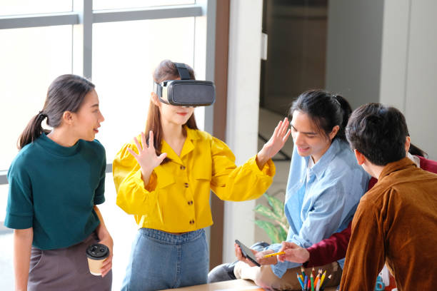 istock VR mobile phone application test, Asian woman with virtual reality glasses headset in VR experience, Asia business team developers for reality simulator smartphone app test at creative office, ui 1328621447