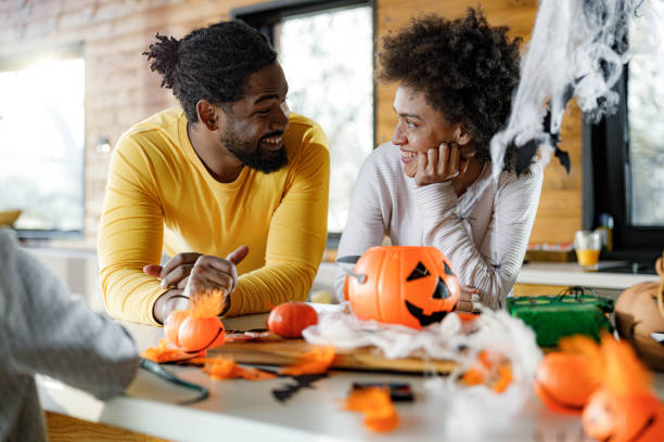 szczęśliwa czarna para rozmawia podczas halloween w domu. - house halloween autumn candid zdjęcia i obrazy z banku zdjęć