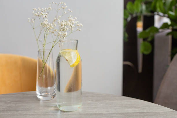 istock Lemon water in a decanter on the table 1328623713