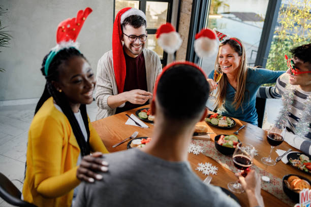 istock Happy friends talking during Christmas lunch at dining table. 1328624038