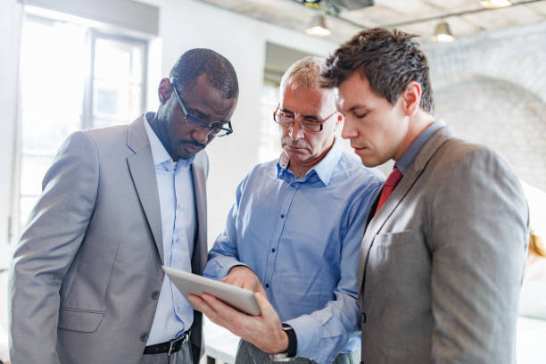 istock Group of businessmen working on touchpad in the office. 1328624826