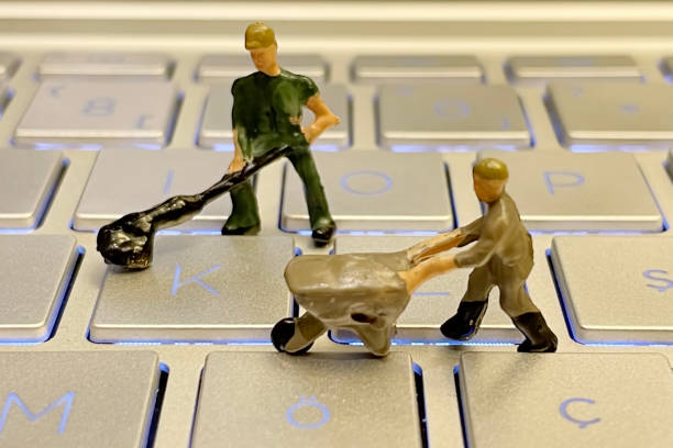 istock IT and computer world and miniature working people. 1328627638
