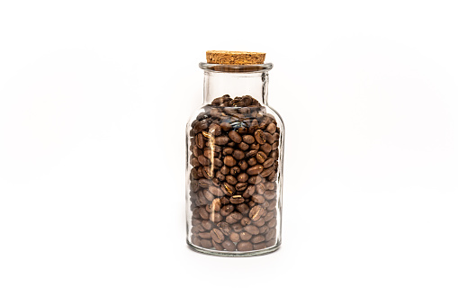 Sealed bottle of coffee beans, glass storage jar isolated on white background.