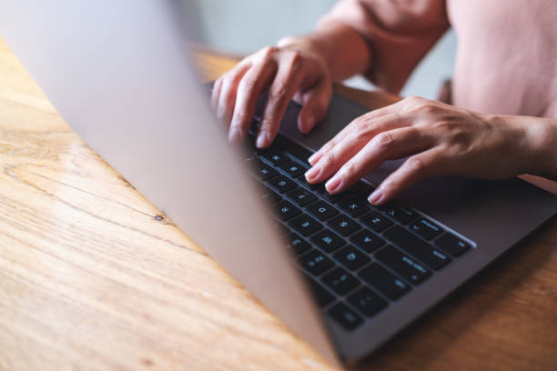 istock a woman working and typing on laptop computer keyboard on the table 1328628868