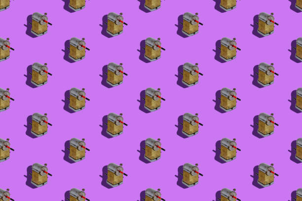 istock Repeated Wooden pencil and vintage sharpener on Lilac background 1328629937