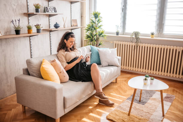 istock Pregnant woman using digital tablet at home 1328630010
