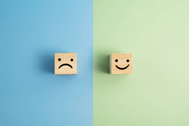 Angry And Smiley Face Wooden Blocks On Colored Background