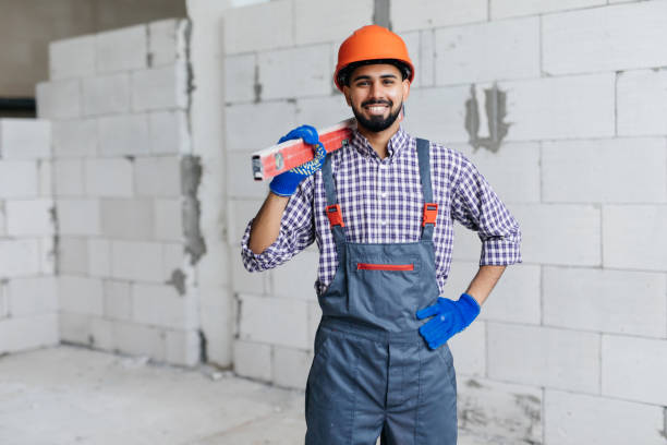 istock Mason checking horizontal level of house wall layer being made from aerated autoclaved blocks 1328633499